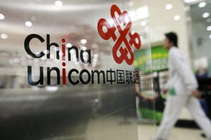 China Unicom logo on doors with person walking in background