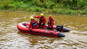 Search and rescue team on a river in a rubber dinghy.
