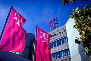 Deutsche Telekom logo on flags and building Deutsche Telekom logo on flags and building