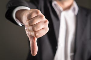 Businessman showing thumbs-down gesture