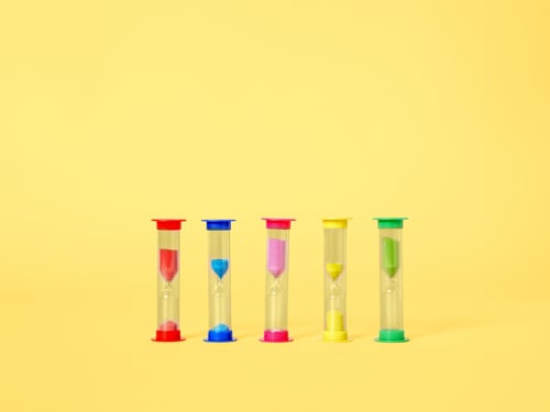 yellow back ground with 5 colourful hourglasses in different colours