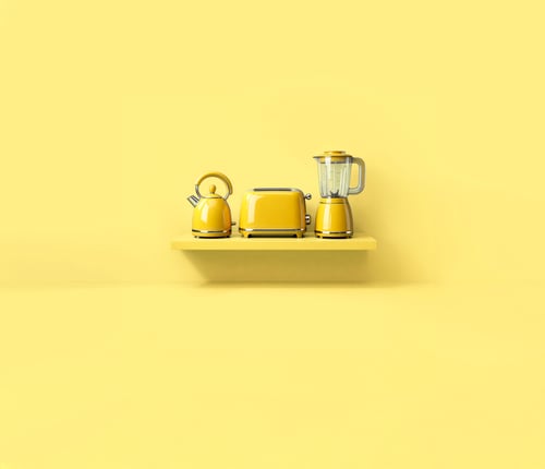 There are 3 kitchen appliance items on a yellow shelf against a yellow background