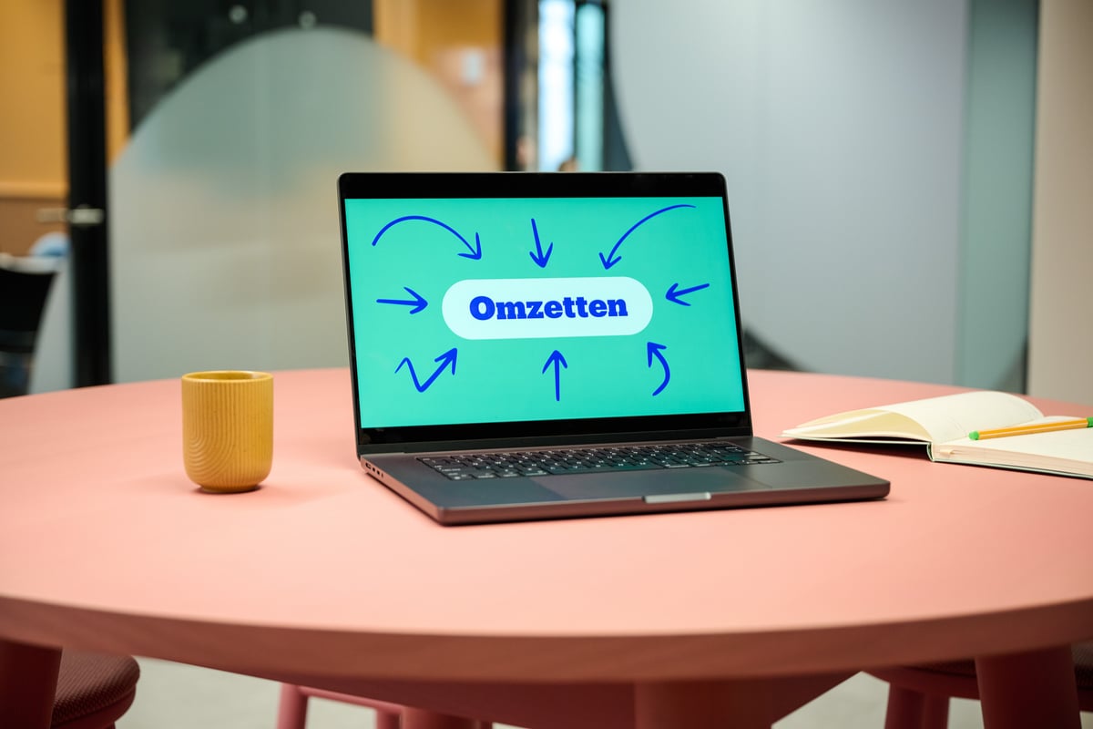 Laptop on table with the word 'turnover' on the screen