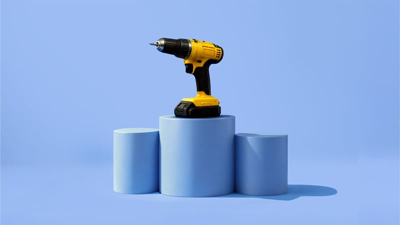 A yellow cordless drill is placed on blue cylindrical pedestals against a blue background.