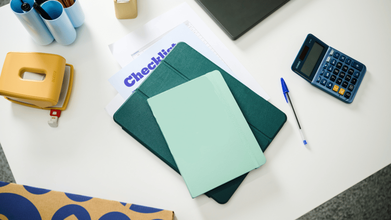 checklist and booklet on white table