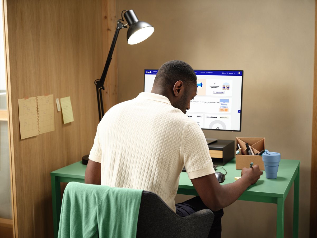 Man working on his computer, logged into his seller account.