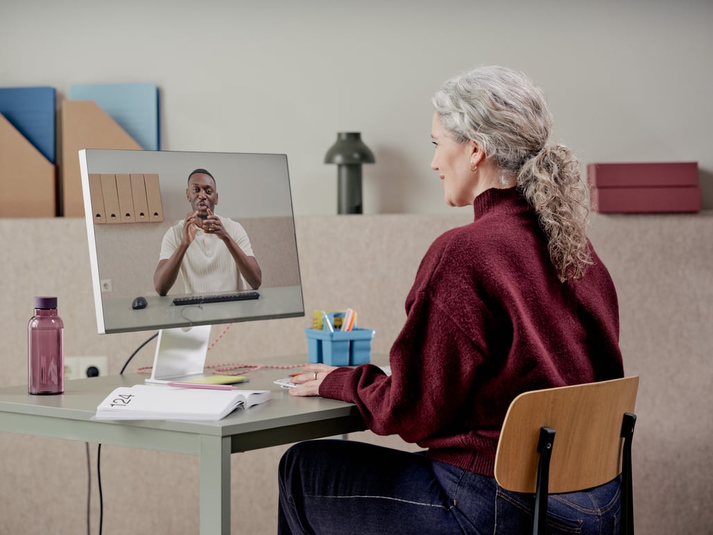 partner behind a laptop in a video call with a partner on a screen