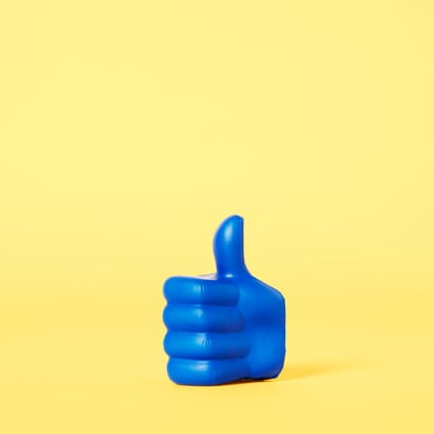 Blue thumbs up on a yellow background