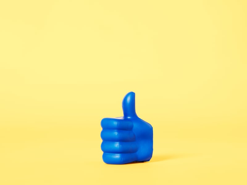 Blue thumb on yellow background
