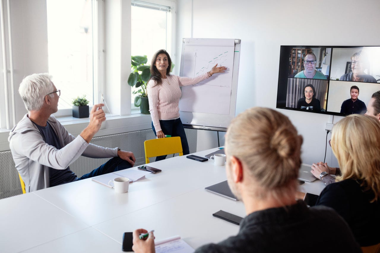 People doing a hybrid meeting People doing a hybrid meeting