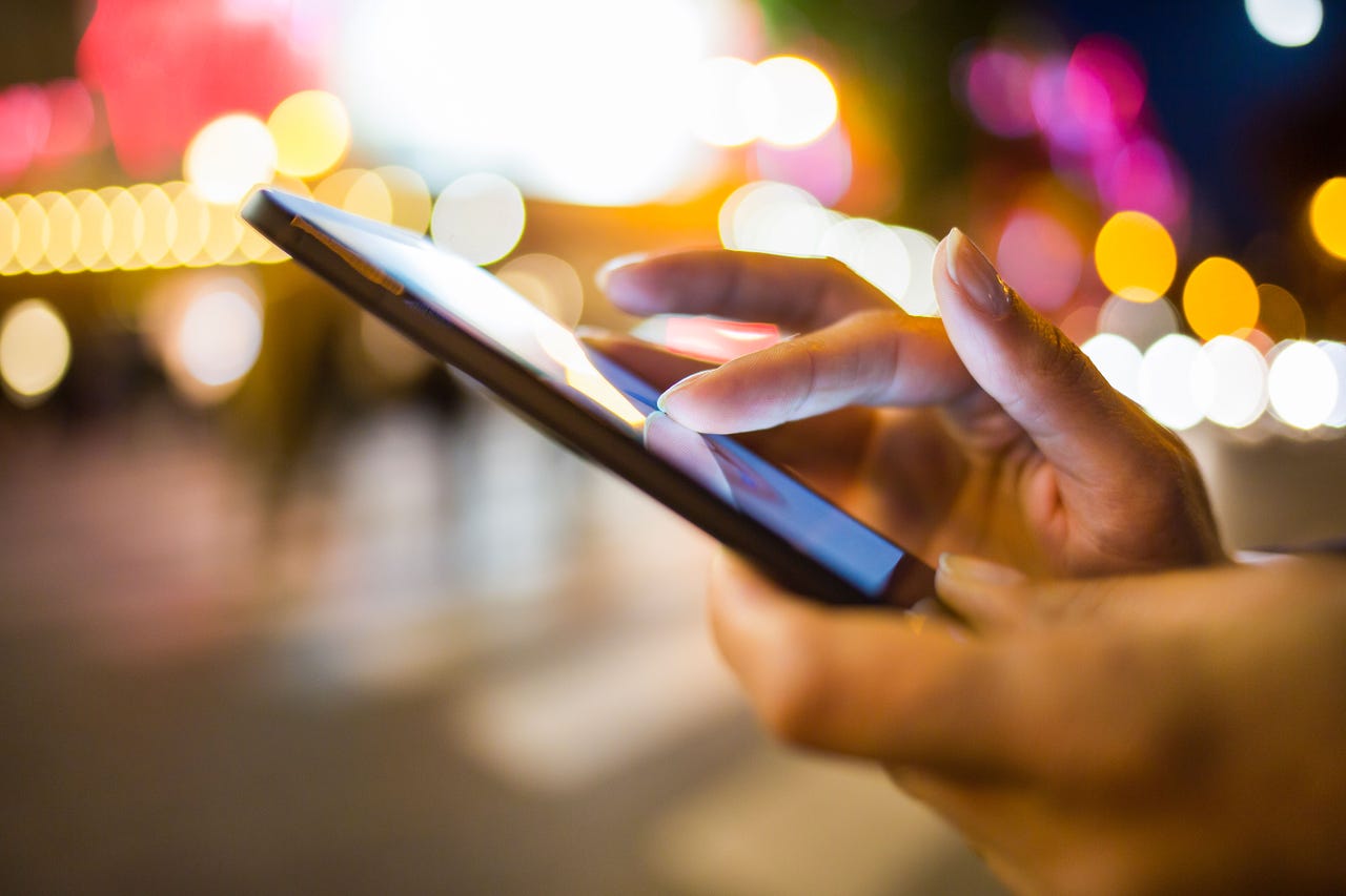 Woman using a mobile phone for SMS messaging Woman using a mobile phone for SMS messaging