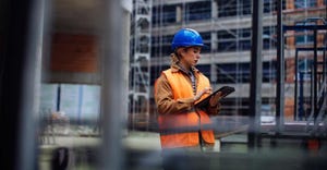 Woman with construction hat on jobsite