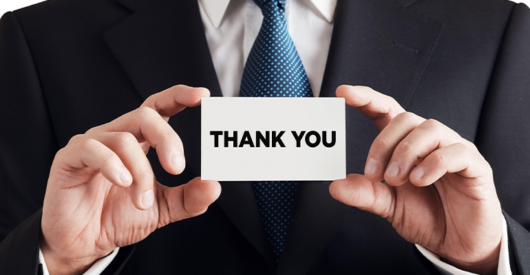 Businessman shows business card with the word thank you. Customer service gratitude concept