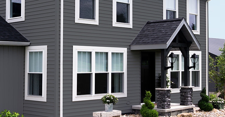 Insulated vinyl on residential home highlighting fiber cement siding vs. vinyl siding