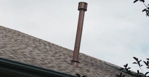 A vent pipe extending high above the roof surface