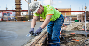 Concrete worker at construction site.