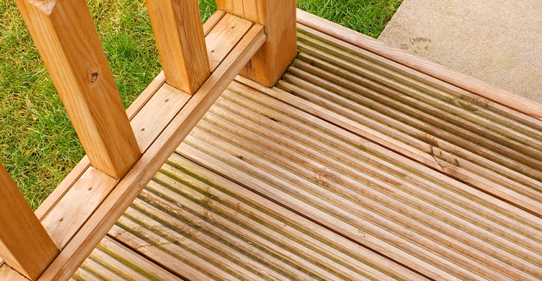 Corner profile of wooden garden decking a popular feature outside modern homes
