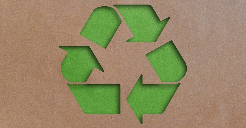 recycling symbol cut out of brown recycled paper