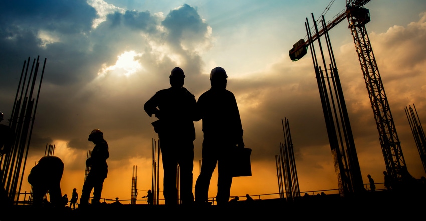 Silhouette Workers Working At Construction Site Against Cloudy Sky During Sunset