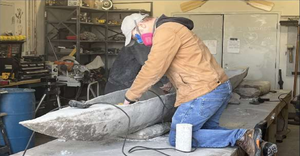 Students from Kennesaw State University work on their concrete canoe.