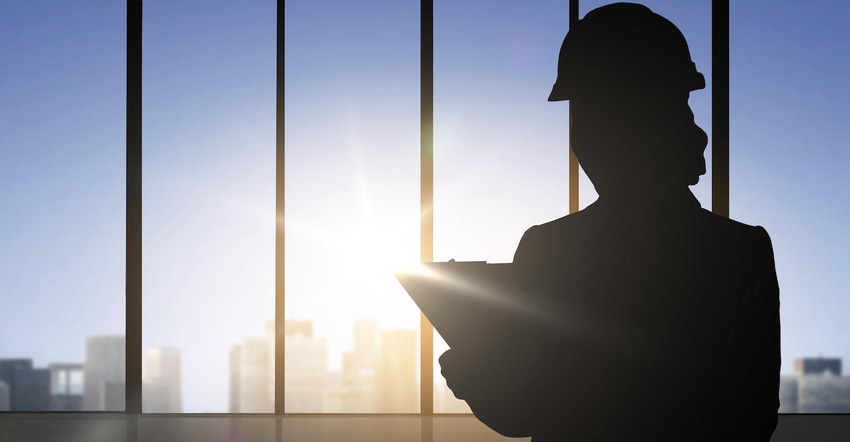 Silhouette of a woman wearing a construction helmet with clipboard.
