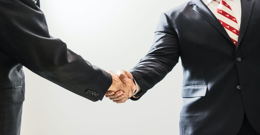 Two men in suits shaking hands.jpg