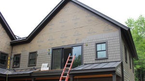 Exterior of home being clad in fiber cement shingles