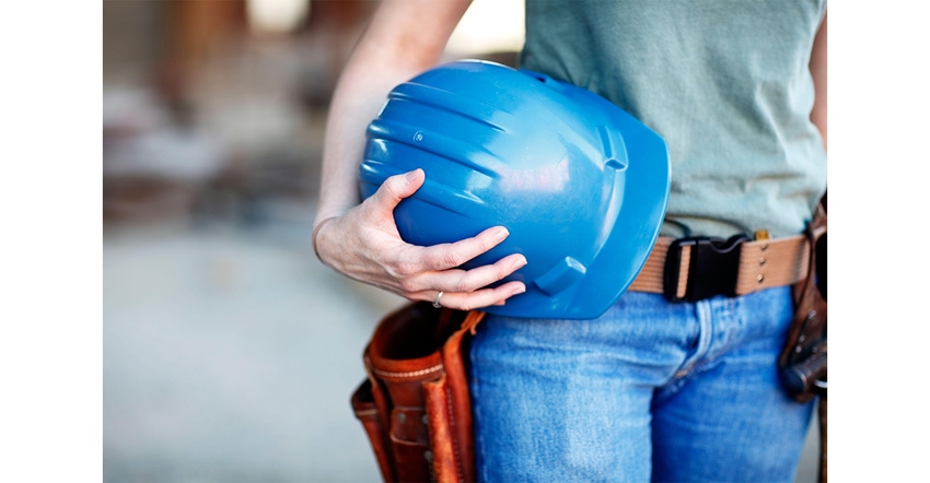Close up of a female construction worker holding a hard hat 