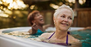 Happy senior women exercising together in a swimming pool.