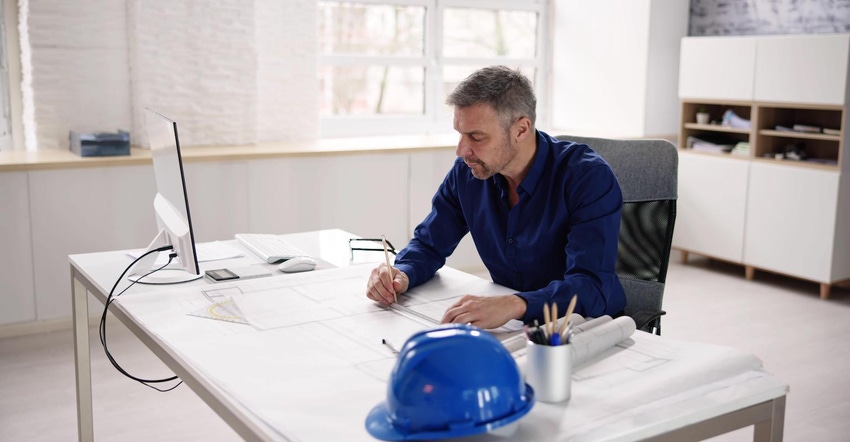 Construction worker pondering plans for retirement and a succession plan at his construction company
