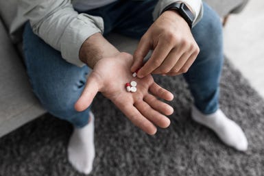 Man will pills in his hand
