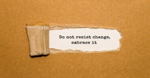 Tearing away at a box to uncover a message that says don't resist change—embrace it