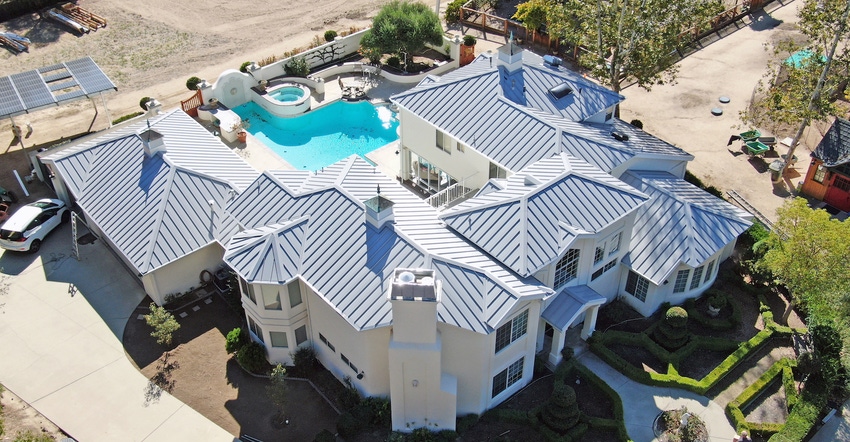 ATAS International Residential Property of the Year grey roof on top of white house with pool in the backyard