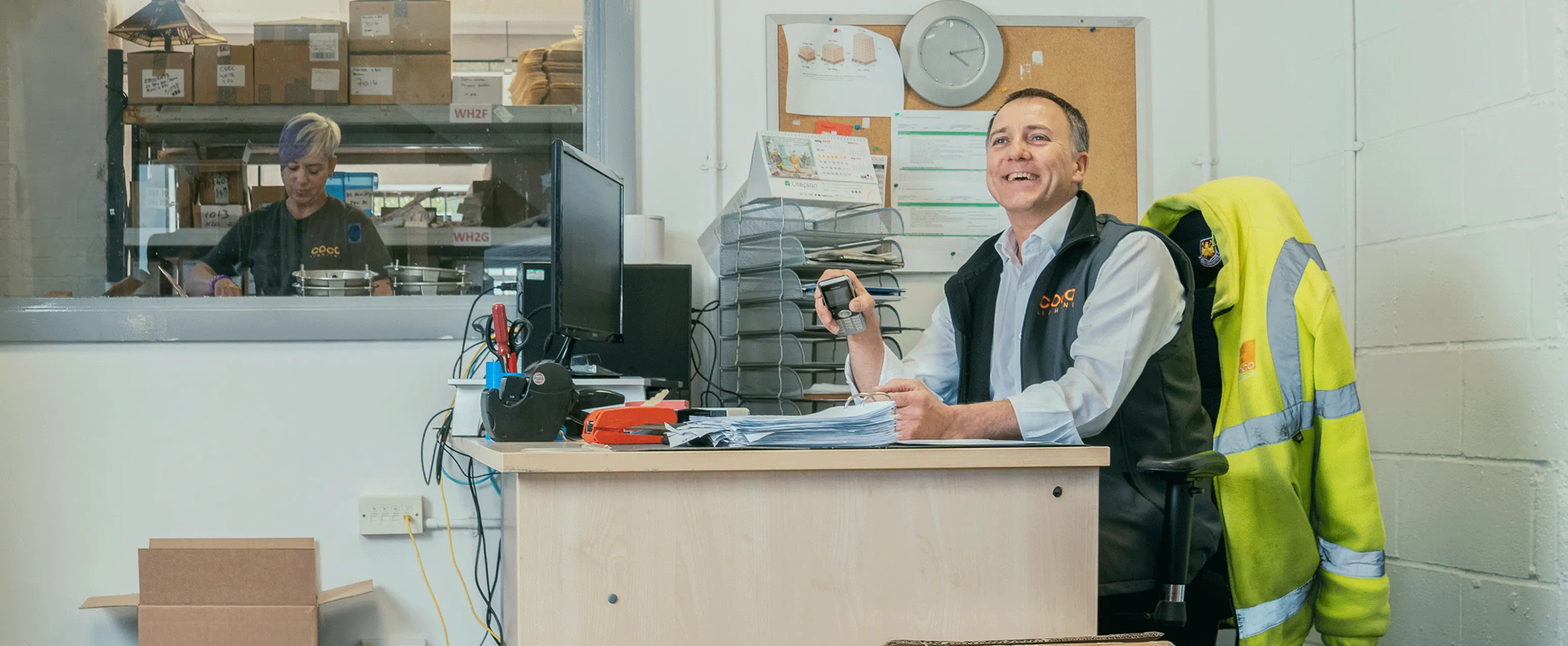 Man at office desk smiling