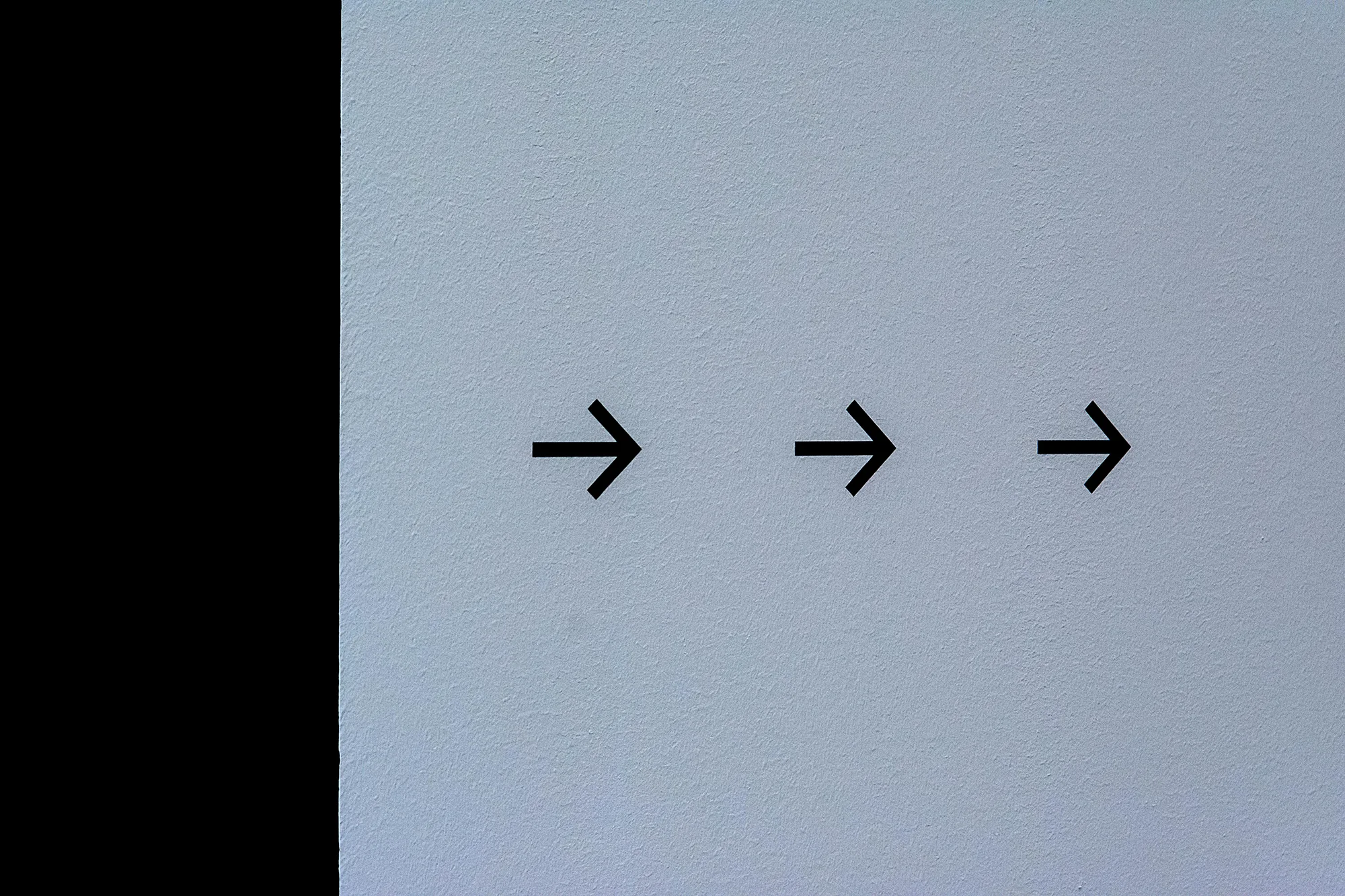 Arrows on a wall moving forwards