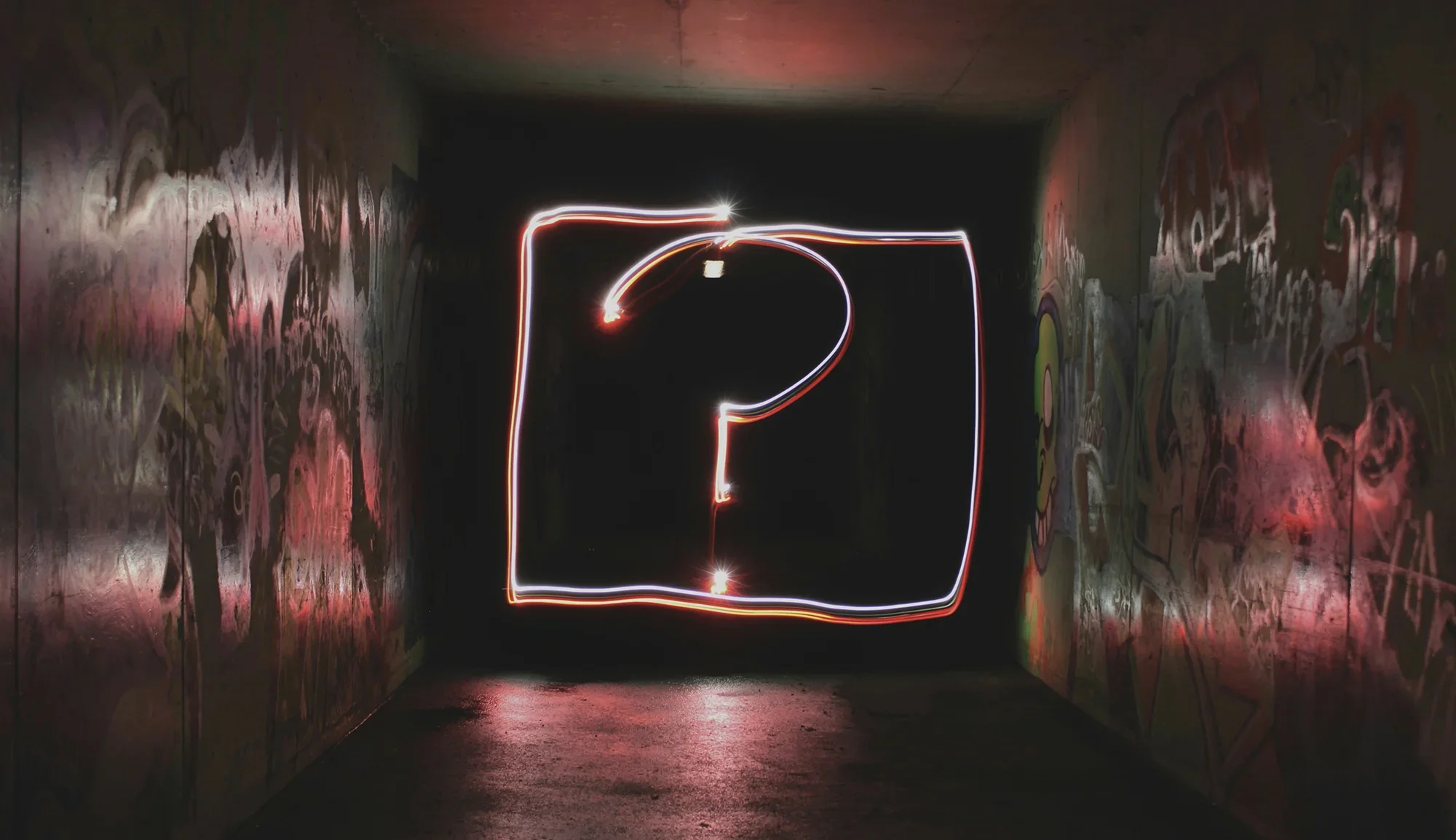 Neon question mark on a dark background