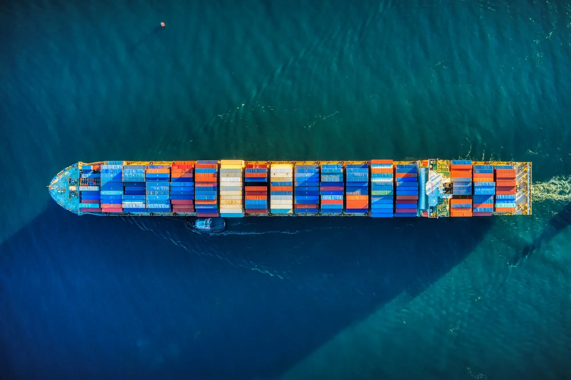 Container ship on the ocean top down view.