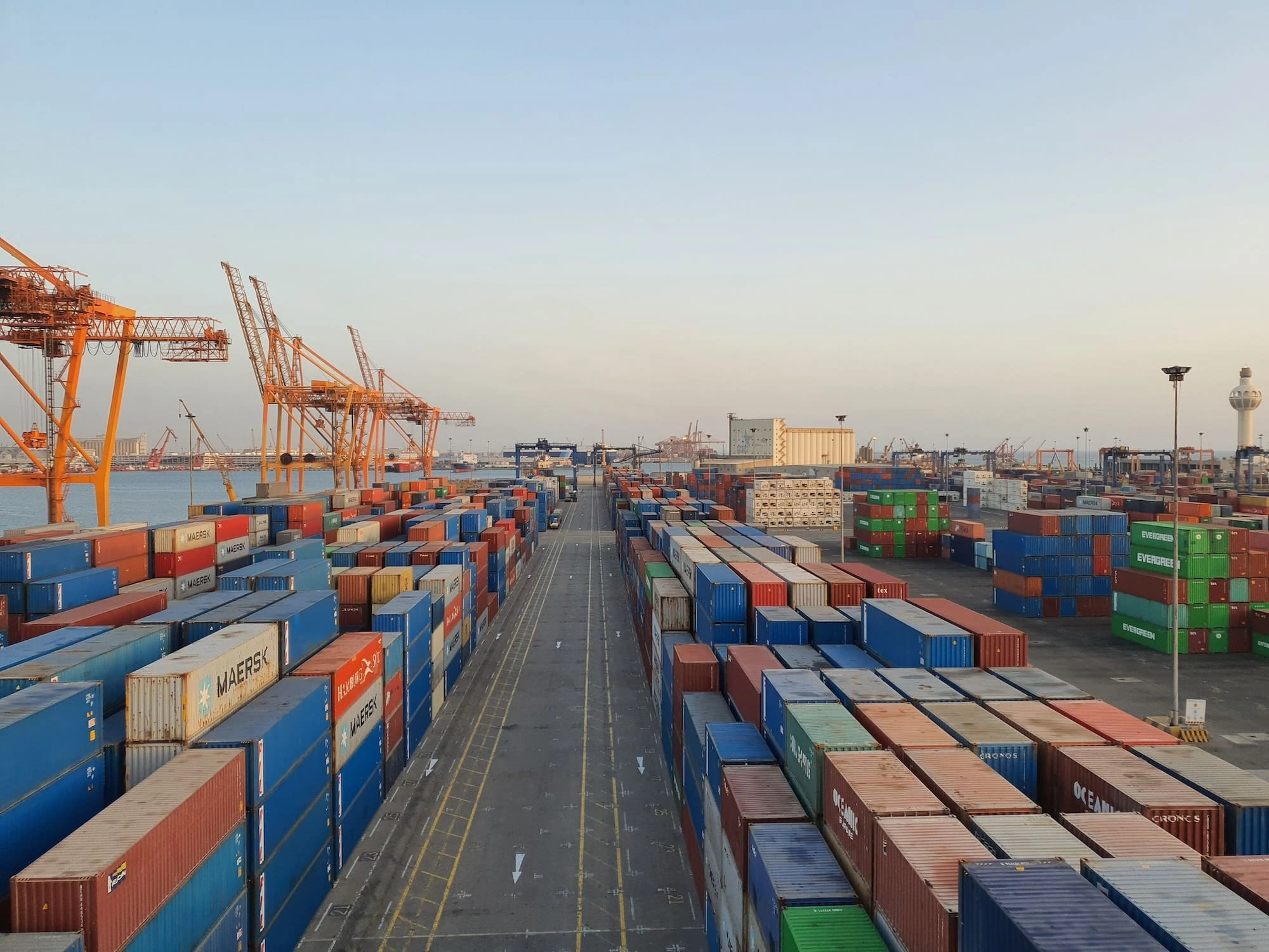 Shipping containers stacked in port.