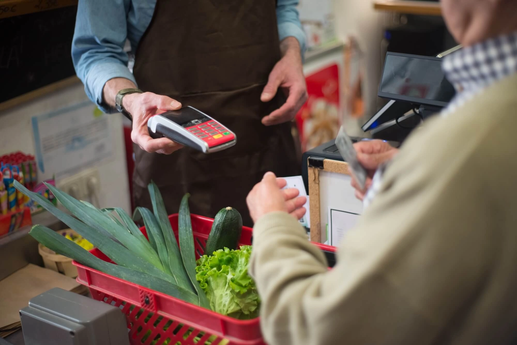 Business owner making a purchase with a credit card in store.