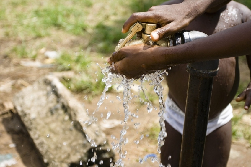 Image shows a child's hands under running water Image shows a child's hands under running water