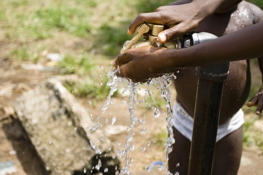 Image shows a child's hands under running water