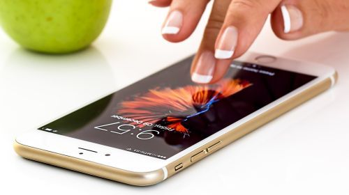 Image of woman touching a smartphone screen Image of woman touching a smartphone screen