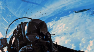 A fighter jet pilot looks at a 'wingman' - the XQ-58A Valkyrie