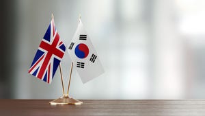 The flags of the U.K. and the Republic of Korea on a desk with a blurred background
