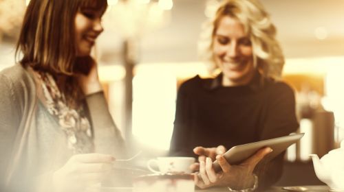 Photo of two women looking at a tablet computer