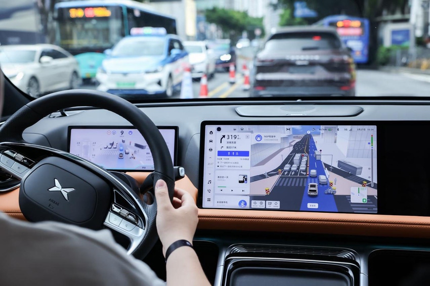 A driver behind the wheel of a vehicle using XPeng's advanced driver assistance technology.