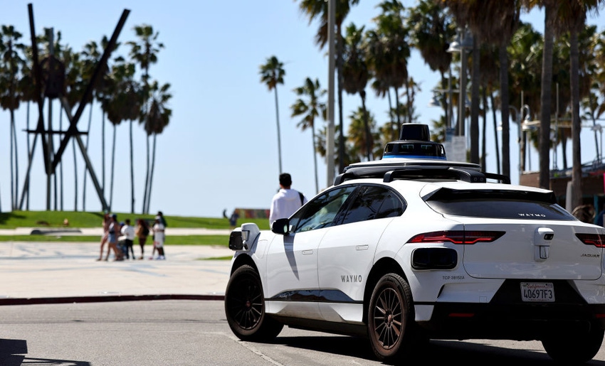 A Waymo autonomous self-driving Jaguar taxi drives along Venice Beach on March 14, 2024 in Los Angeles, California.