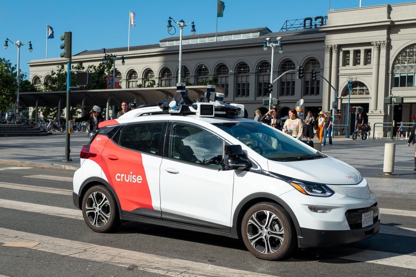 A General Motors Cruise self driving car, often referred to as a robotaxi, drives in front of the Ferry Building on the Embarcedero, San Francisco.