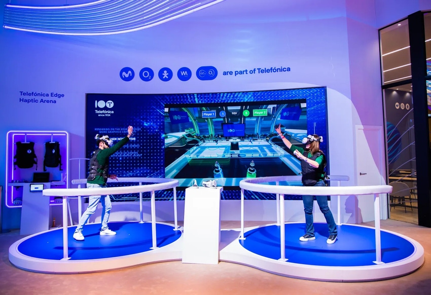 Two people playing a game in Telefonica's immersive haptic-enhanced VR gaming experience