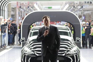 Image shows Tesla CEO Elon Musk speaks during the official opening of the new Tesla electric car manufacturing plant on March
